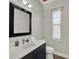 Half bath features modern fixtures, a large mirror, and decorative accents at 1281 Grand Traverse Pkwy, Reunion, FL 34747