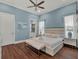 Comfortable bedroom with ensuite bathroom, ceiling fan and hardwood floors, offering a relaxing space at 1281 Grand Traverse Pkwy, Reunion, FL 34747