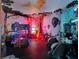 Whimsical bedroom featuring vibrant murals, a custom bunk bed and a themed play area at 1281 Grand Traverse Pkwy, Reunion, FL 34747