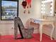 Glamorous vanity area with statement chair and illuminated makeup mirror at 1281 Grand Traverse Pkwy, Reunion, FL 34747