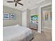 Cozy bedroom featuring a stylish dresser, ceiling fan, and two pieces of artwork at 1281 Grand Traverse Pkwy, Reunion, FL 34747