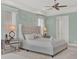 The bedroom features a high, tufted headboard, mirrored nightstands, and calm colors at 1281 Grand Traverse Pkwy, Reunion, FL 34747