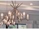 Stylish chandelier features unique starburst design with glass accents enhancing the light and room ambiance at 1281 Grand Traverse Pkwy, Reunion, FL 34747