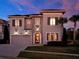 Stately two-story home with a lush lawn, stone accents, and a welcoming entrance at 1281 Grand Traverse Pkwy, Reunion, FL 34747