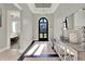 Light-filled foyer features a decorative mirror, console table, and arched doorway, adding character at 1281 Grand Traverse Pkwy, Reunion, FL 34747