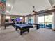 Game room includes a pool table, shuffleboard table, and a wall with dual screen gaming setup at 1281 Grand Traverse Pkwy, Reunion, FL 34747