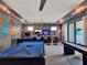Spacious game room with wall to wall mural, arcade games, and dual screen video gaming at 1281 Grand Traverse Pkwy, Reunion, FL 34747