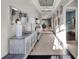 Hallway with recessed lights and elegant console tables leads to an open concept living area at 1281 Grand Traverse Pkwy, Reunion, FL 34747