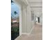 Long hallway showcasing neutral paint, white trim, and artwork leading to a game room with mural at 1281 Grand Traverse Pkwy, Reunion, FL 34747