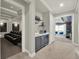 Hallway featuring a wet bar that connects to a home theatre and adjacent game room at 1281 Grand Traverse Pkwy, Reunion, FL 34747