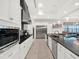 Modern kitchen with stainless steel appliances, sleek countertops, and white cabinetry at 1281 Grand Traverse Pkwy, Reunion, FL 34747