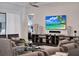 Comfortable living room features a ceiling fan, a large TV, and access to another room at 1281 Grand Traverse Pkwy, Reunion, FL 34747