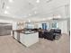Bright open-concept living space featuring a kitchen island and multiple seating areas at 1281 Grand Traverse Pkwy, Reunion, FL 34747