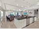 A spacious open-concept living area with a kitchen island, dining area, and comfortable seating at 1281 Grand Traverse Pkwy, Reunion, FL 34747
