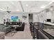 Stylish living room with kitchen bar, comfortable seating, and a large-screen television at 1281 Grand Traverse Pkwy, Reunion, FL 34747