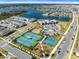 Beautiful aerial view of community with tennis courts, pool, and lake at 13676 Mcmillan Dr, Orlando, FL 32827