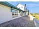 Expansive brick patio, perfect for outdoor gatherings and relaxation, with views of the landscaped backyard at 13676 Mcmillan Dr, Orlando, FL 32827