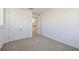 Well-lit bedroom with a neutral carpet, double door closet, and doorway leading to the hall at 13676 Mcmillan Dr, Orlando, FL 32827