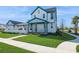 Beautiful two-story home with a covered porch and lush green lawn at 13676 Mcmillan Dr, Orlando, FL 32827