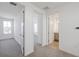 Bright hallway featuring doorways to bedrooms and a bathroom, all freshly painted with neutral carpet at 13676 Mcmillan Dr, Orlando, FL 32827
