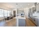 Modern kitchen with gray cabinets, stainless steel appliances, and a center island at 13676 Mcmillan Dr, Orlando, FL 32827