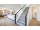 Open-concept living space with a staircase, wood-look flooring, and modern design at 13676 Mcmillan Dr, Orlando, FL 32827
