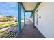 Charming porch with turquoise columns and a textured brick floor, ideal for relaxing and enjoying the outdoors at 13676 Mcmillan Dr, Orlando, FL 32827