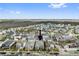 Expansive aerial view of a well-planned community surrounded by natural landscapes under blue skies at 13759 Mommsen Ave, Orlando, FL 32827