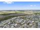 Sprawling aerial view showcasing community of homes near green wooded areas at 13759 Mommsen Ave, Orlando, FL 32827