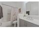 Bright bathroom featuring a white tiled shower with a decorative shower curtain and modern sink at 13759 Mommsen Ave, Orlando, FL 32827