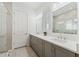 Modern bathroom features double sinks, sleek gray cabinets, and a glass-enclosed shower at 13759 Mommsen Ave, Orlando, FL 32827