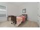 Bright bedroom with a twin bed, wood-style tile floors, and a side table by the window at 13759 Mommsen Ave, Orlando, FL 32827