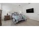 Cozy bedroom boasts a comfortable bed, neutral tones, and a mounted TV at 13759 Mommsen Ave, Orlando, FL 32827