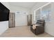 Bedroom featuring wood-look floors, storage cabinets, a black leather recliner and natural light from the windows at 13759 Mommsen Ave, Orlando, FL 32827