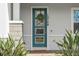 A stylish front door with decorative glass and a welcoming wreath, adding character to the home at 13759 Mommsen Ave, Orlando, FL 32827