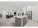 Open-concept kitchen with a large center island, stainless steel appliances, and modern finishes at 13759 Mommsen Ave, Orlando, FL 32827
