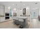 Bright kitchen featuring an island with bar seating, stainless steel appliances, and ample counter space at 13759 Mommsen Ave, Orlando, FL 32827