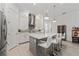 Spacious kitchen island with seating and pendant lights, complemented by stainless steel appliances at 13759 Mommsen Ave, Orlando, FL 32827
