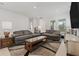 Bright living room showcasing stylish furniture, a modern rug, and neutral decor at 13759 Mommsen Ave, Orlando, FL 32827