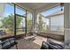Screened-in patio with brick flooring, comfortable seating, and an outdoor hanging chair at 13759 Mommsen Ave, Orlando, FL 32827