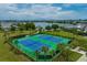 Scenic view of tennis courts with a lake and community in the distance at 13759 Mommsen Ave, Orlando, FL 32827