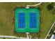 Overhead view of well-maintained tennis courts surrounded by lush green lawns at 13759 Mommsen Ave, Orlando, FL 32827