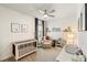 Cozy Bedroom featuring a crib, changing table, and glider at 13916 Destin Beach Ln, Orlando, FL 32827