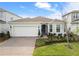 Charming home featuring a well-manicured lawn, lush landscaping, and a paved driveway at 13916 Destin Beach Ln, Orlando, FL 32827