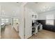 Home office with a stylish design and a view into the living room at 13916 Destin Beach Ln, Orlando, FL 32827
