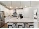 Bright kitchen features a center island with seating and stylish pendant lighting at 13916 Destin Beach Ln, Orlando, FL 32827