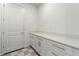 Bright laundry room with white cabinets and a long countertop perfect for folding laundry at 13916 Destin Beach Ln, Orlando, FL 32827