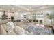 Spacious living room features a modern kitchen and sliding glass doors to the outside at 13916 Destin Beach Ln, Orlando, FL 32827