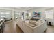 Spacious living room with plush sofa, large windows, and sliding doors to the outdoor patio at 13916 Destin Beach Ln, Orlando, FL 32827