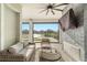 Relaxing screened patio with fan, comfortable seating, and tranquil view of lake at 13916 Destin Beach Ln, Orlando, FL 32827